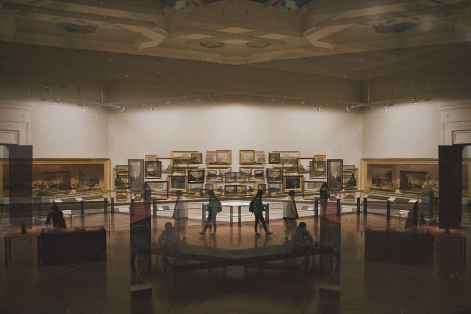 Explore a captivating art gallery interior featuring various artworks and visitors in Melbourne.
